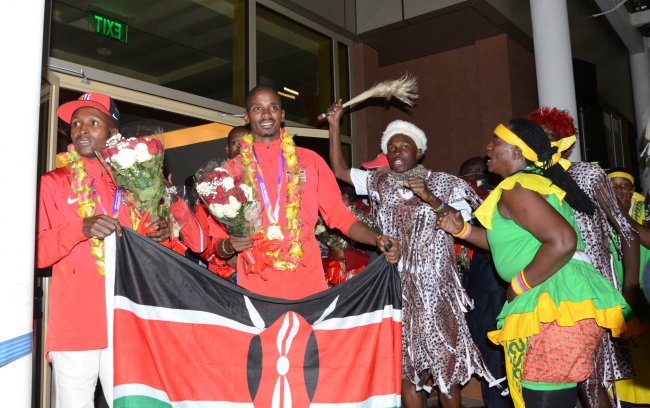 World champions Elijah Manangoi and Geoffrey Kirui lead the Kenya team as they are welcomed at JKIA on Tuesday morning. (Photo by Alex Wafula)